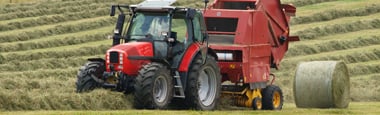 Photo of tractor making hay bales