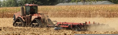 Photo of tractor tilling field